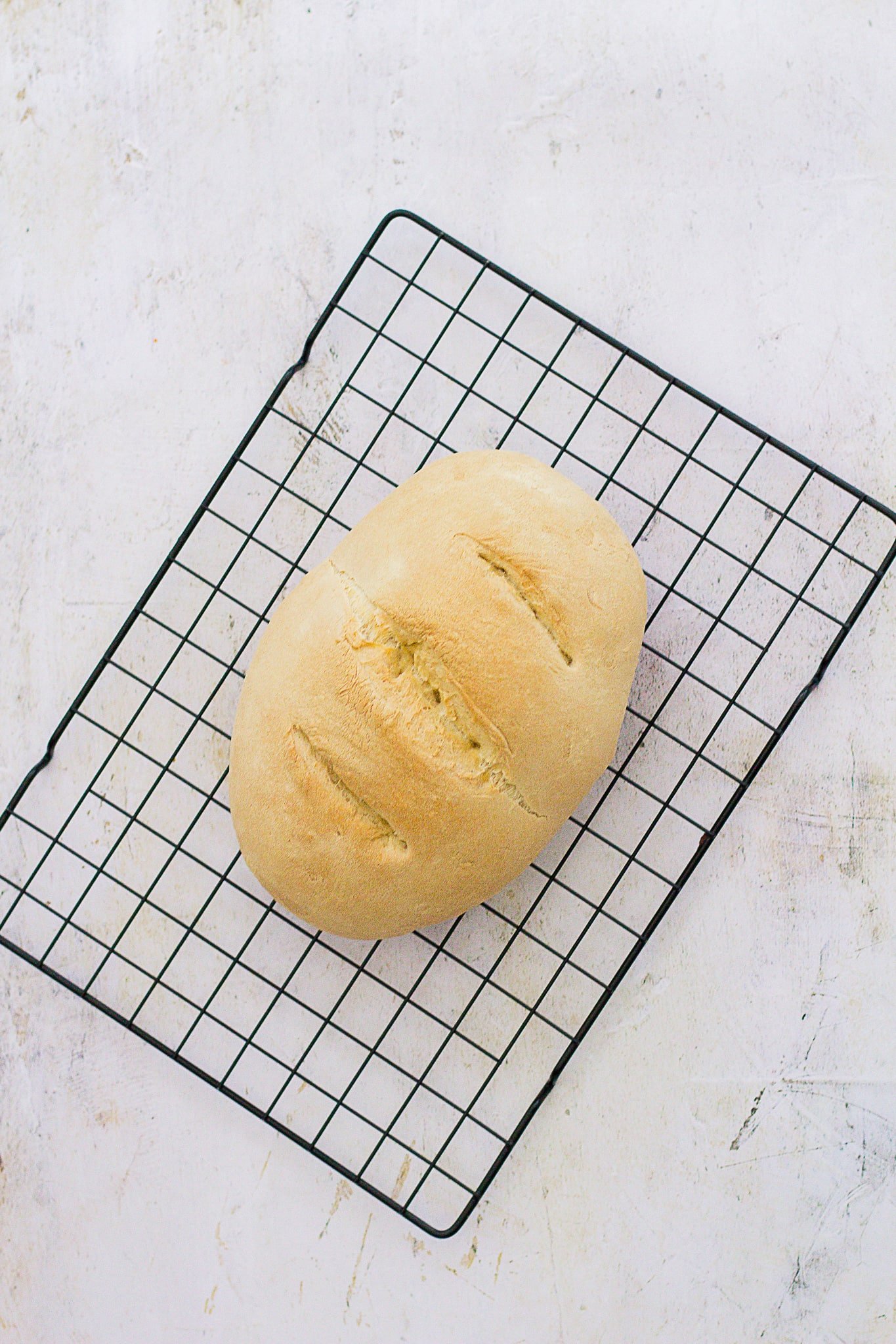 Overhead shot of Super Simple White Bread on a wire cooling rack