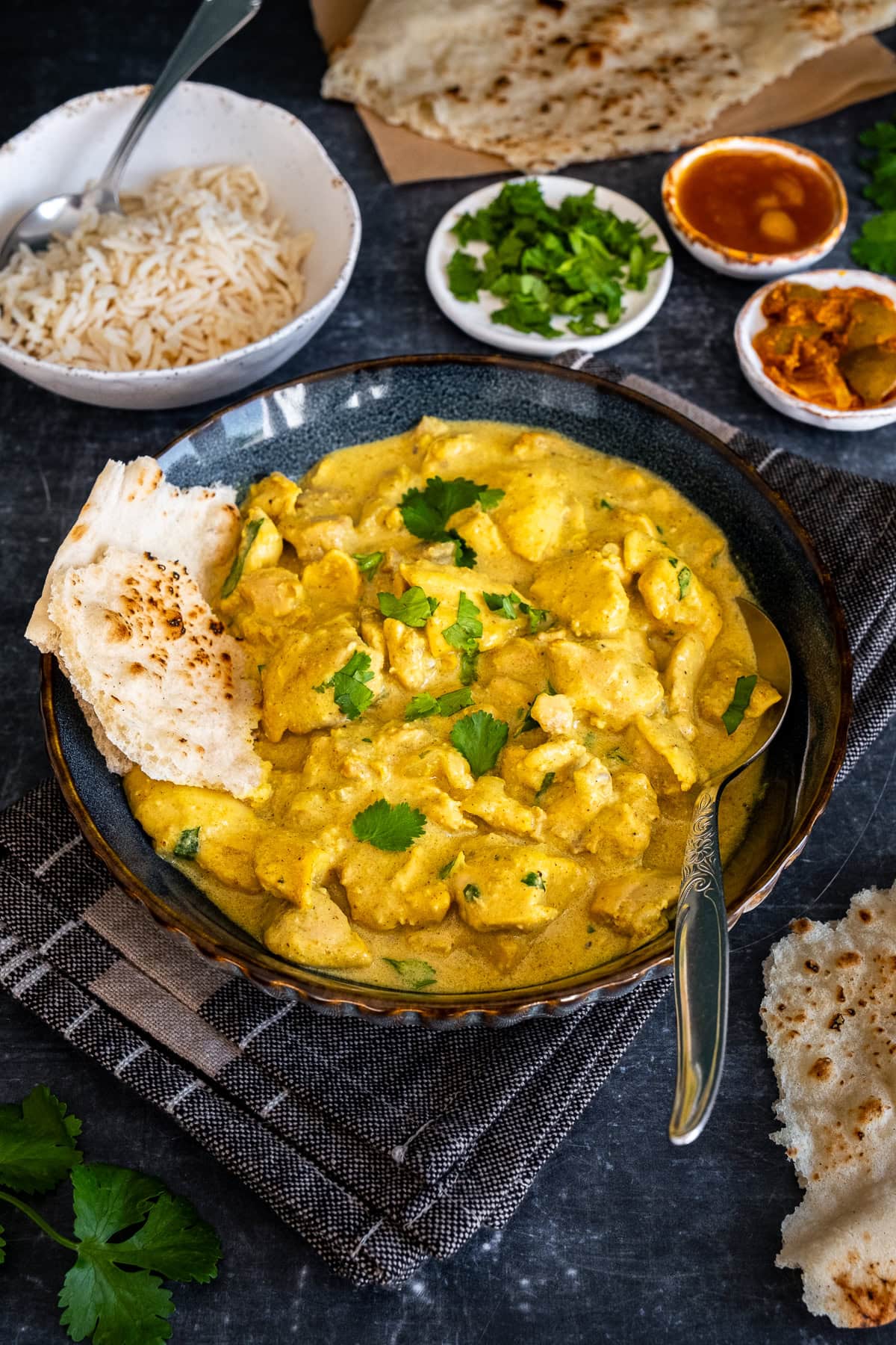 Closeup of Easy Chicken Korma in a bowl with Naan Bread.
