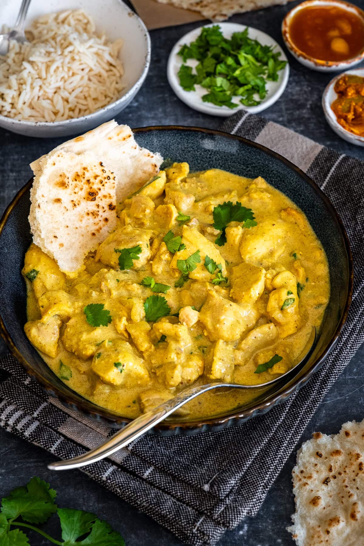 Closeup of Easy Chicken Korma in a bowl with Naan Bread.