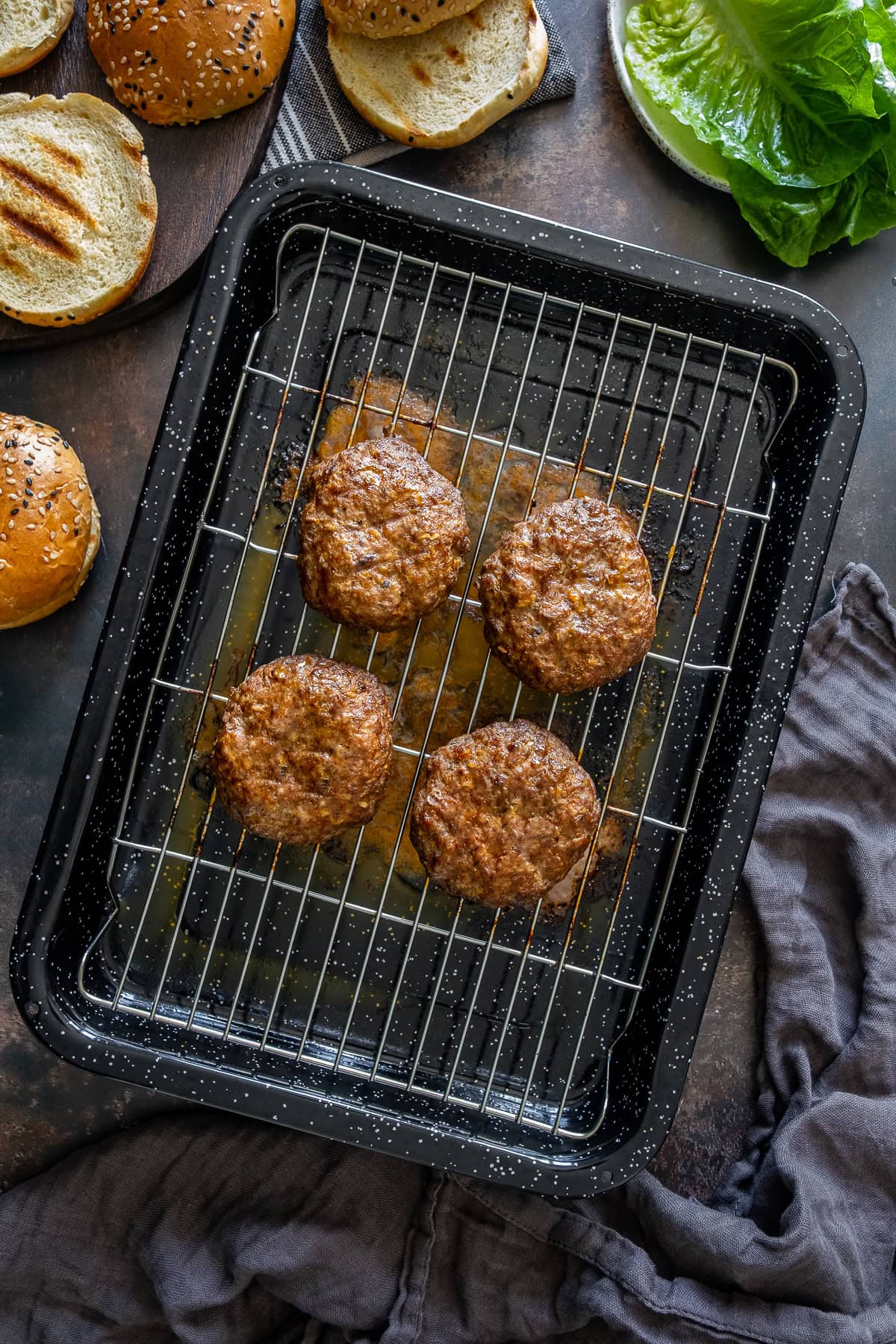 Overhead shot of Easy Homemade Beef Burger Patties on a grill tray.