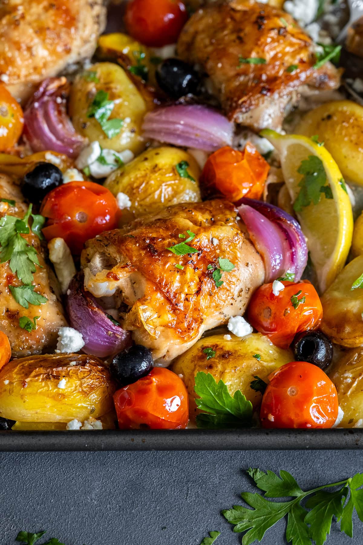 Closeup of Greek Chicken Traybake in the tray.