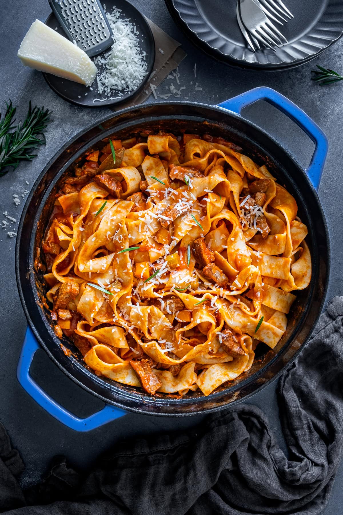 Overheat shot of Leftover Lamb Ragu in the pan with parmesan and rosemary.