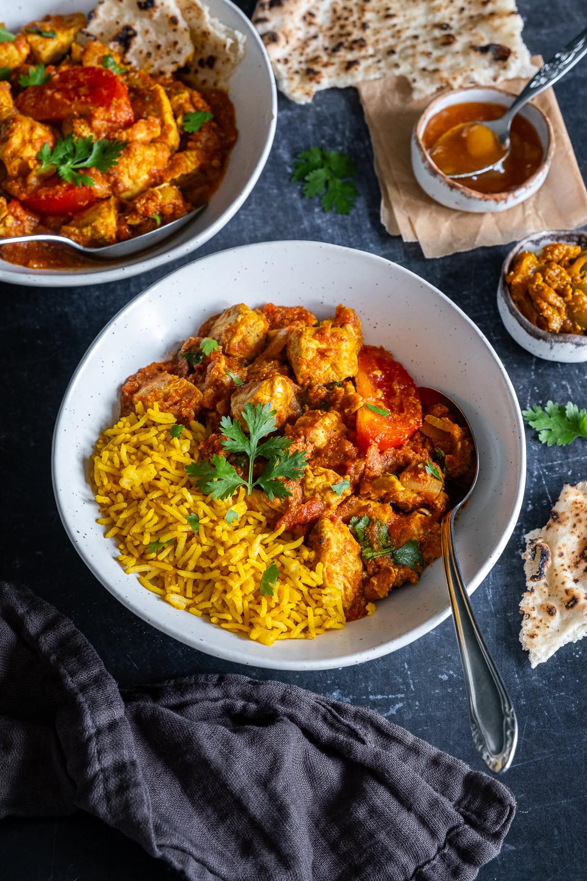 Closeup of Easy Chicken Rogan Josh in a bowl with pilau rice.