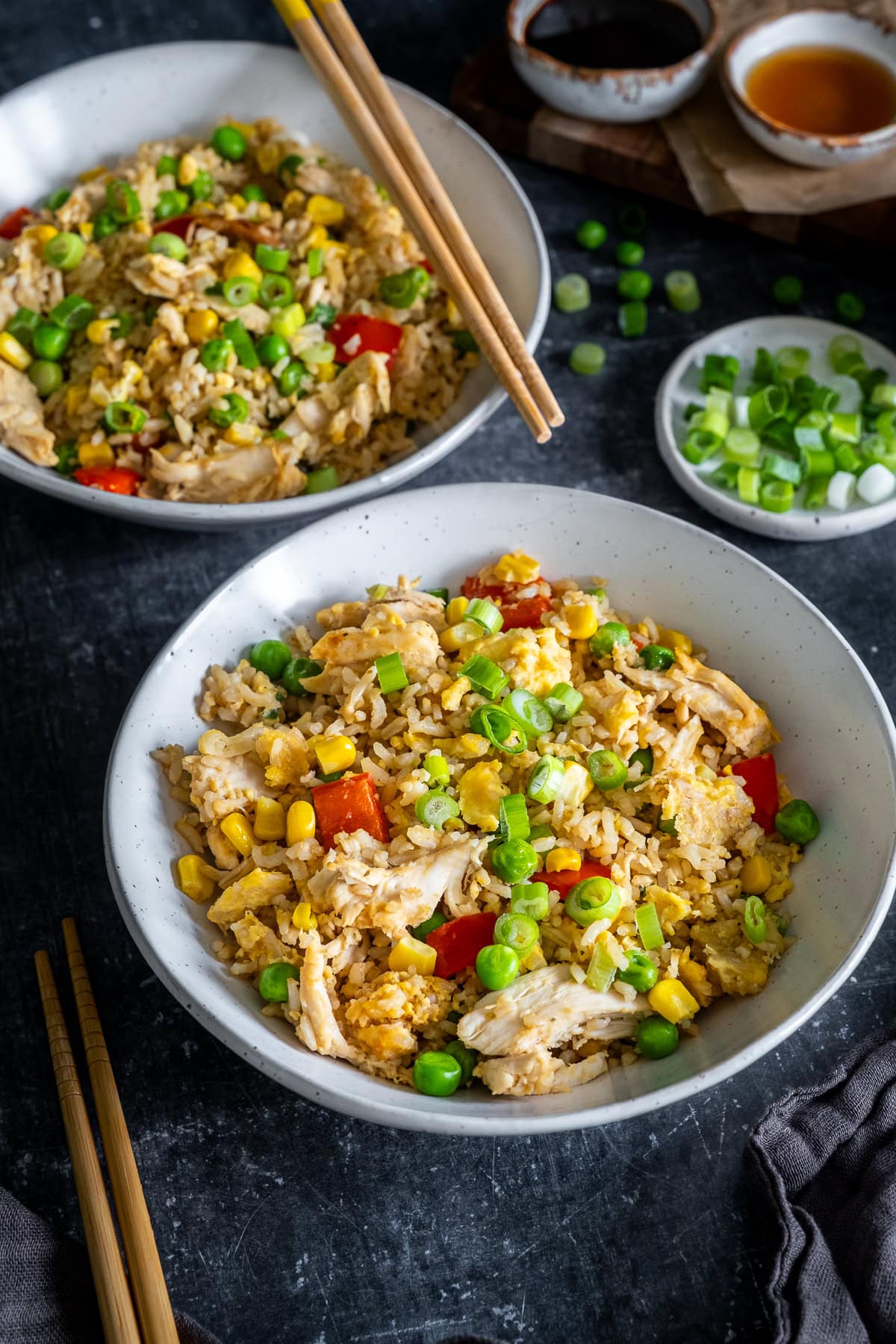 Closeup of 2 bowls of Leftover Chicken and Egg Fried Rice with chopsticks