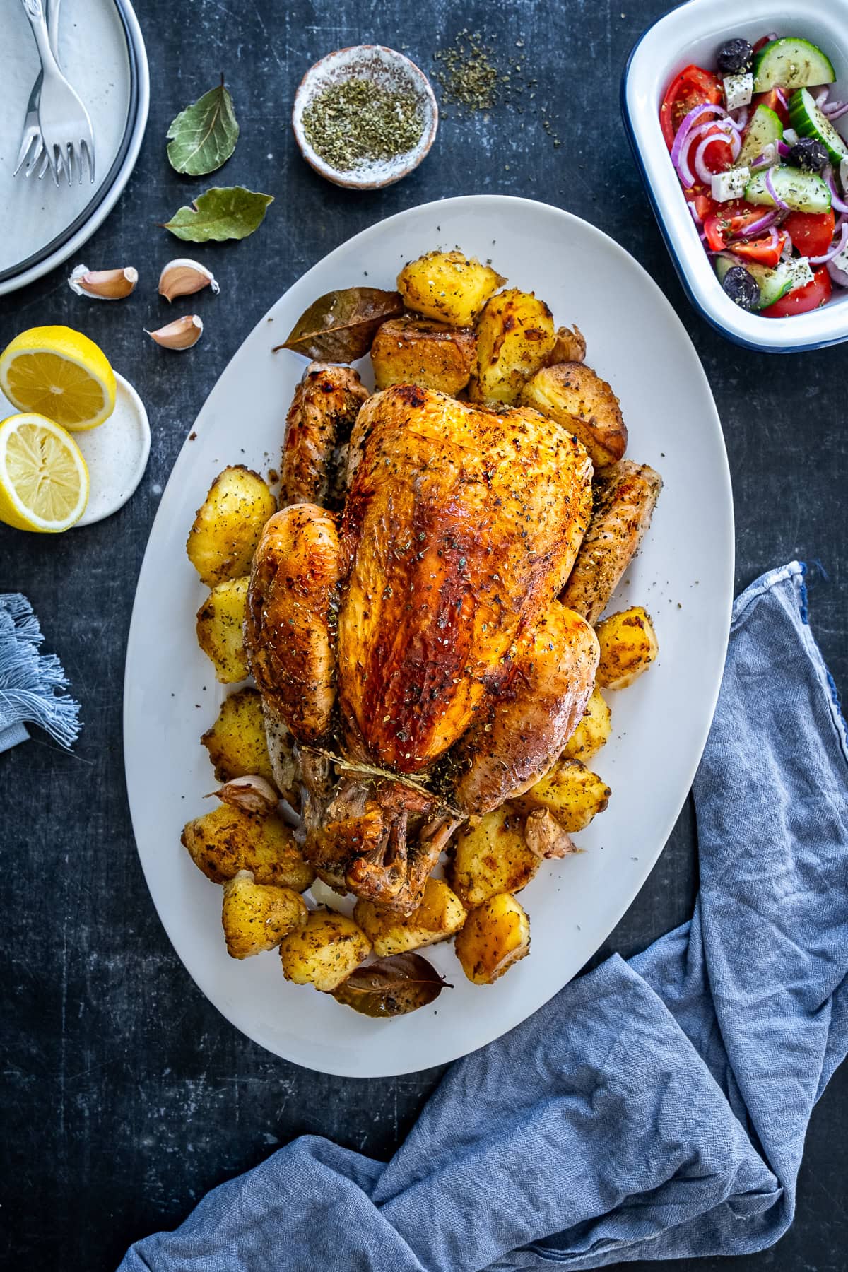 Overhead shot of One Pan Greek Roast Chicken and Roast Potatoes on a serving platter.