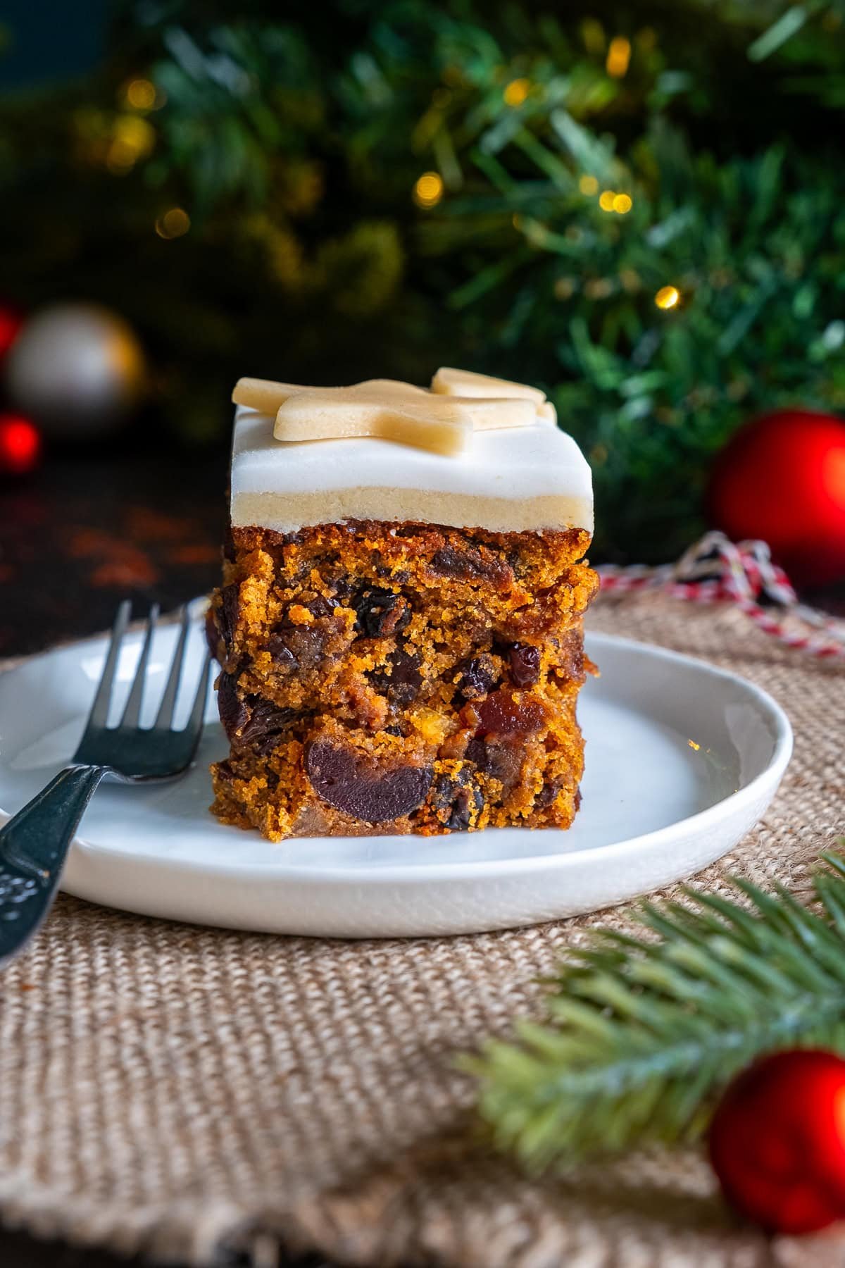 One piece of Easy Christmas Cake Traybake on a plate.