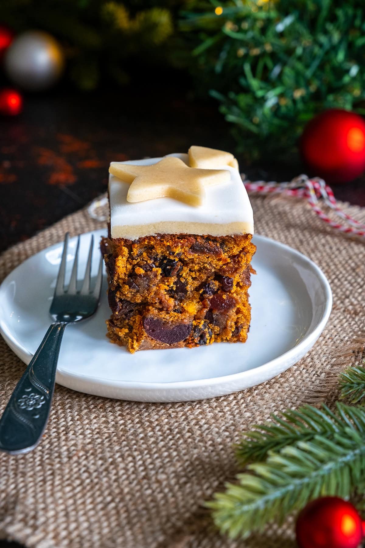 One piece of Easy Christmas Cake Traybake on a plate with a fork.