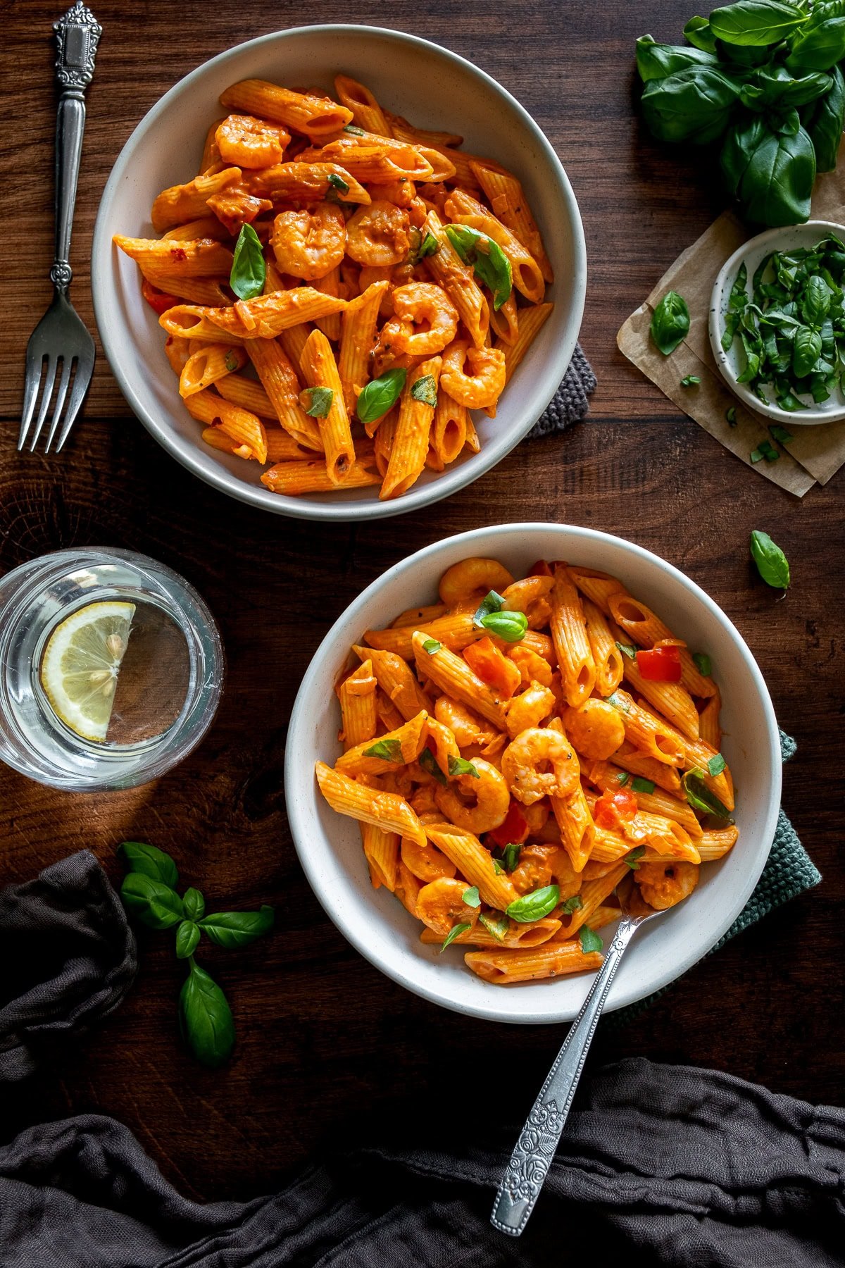 Overhead shot of 2 bowls of Creamy Prawn Tomato Pasta.