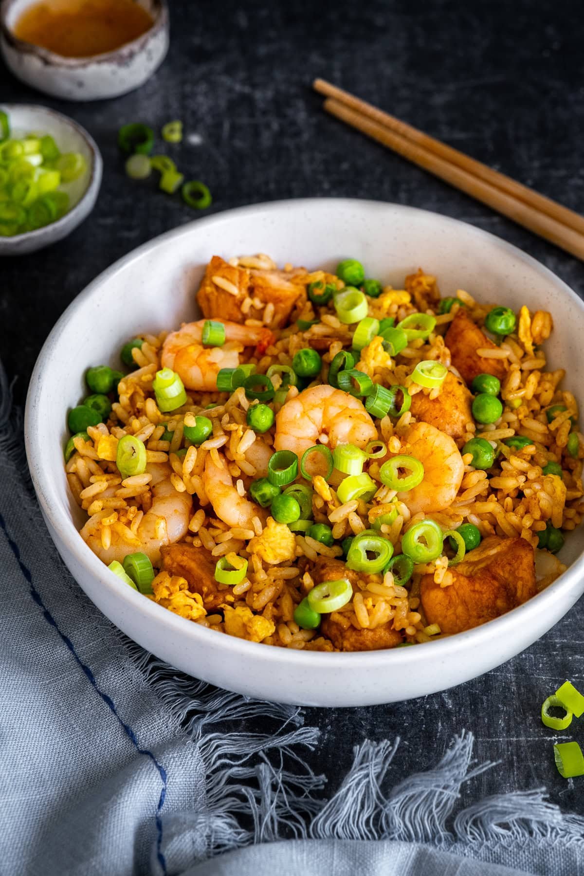 Closeup of Chicken and Prawn Fried Rice in a bowl with chopsticks
