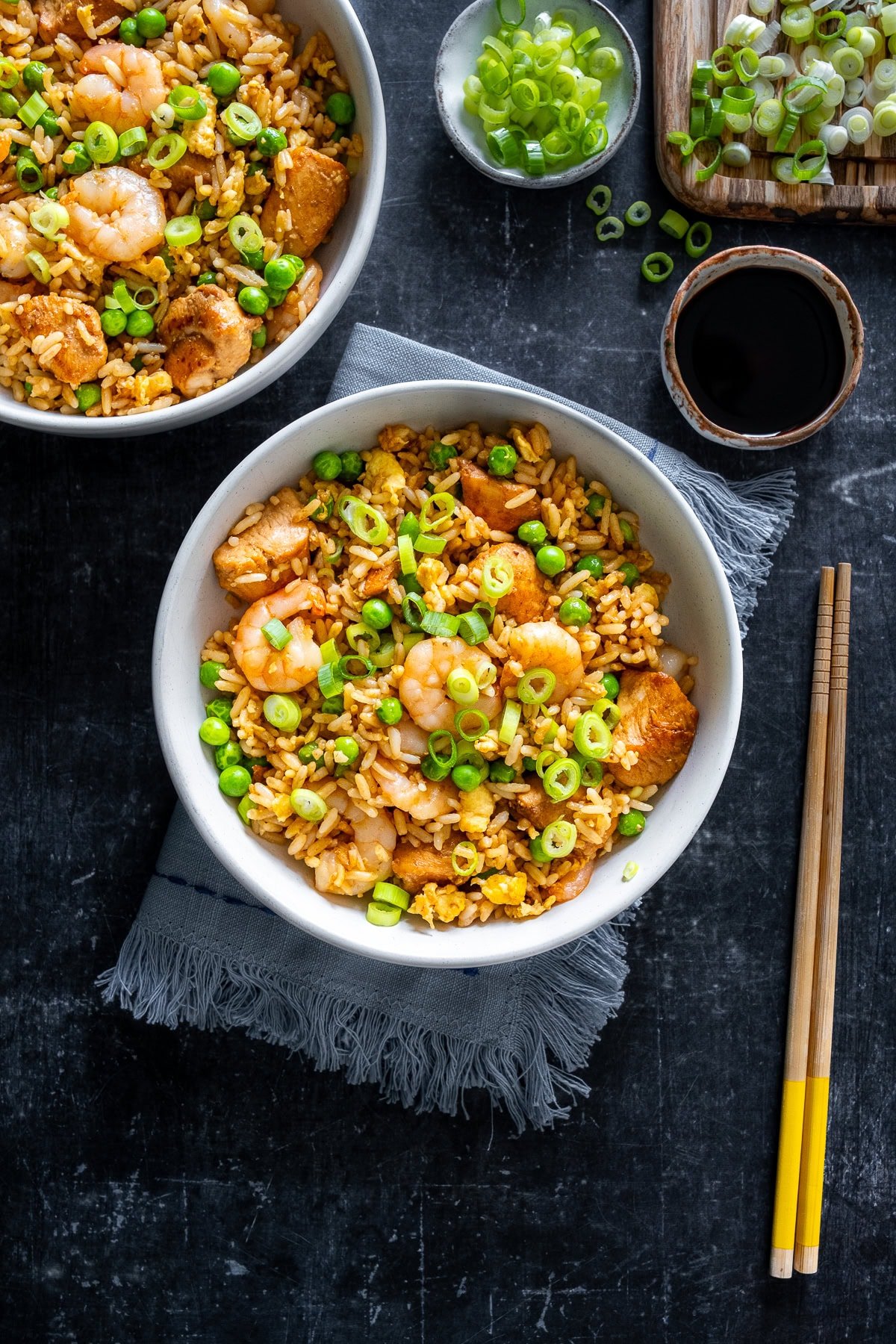 Overhead shot of Chicken and Prawn Fried Rice in a bowl with chopsticks