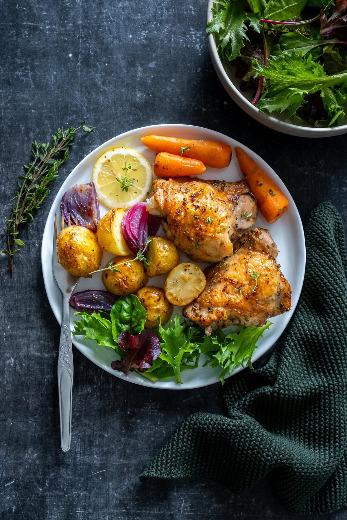 Overhead shot of Chicken and Potato Traybake served onto a plate.