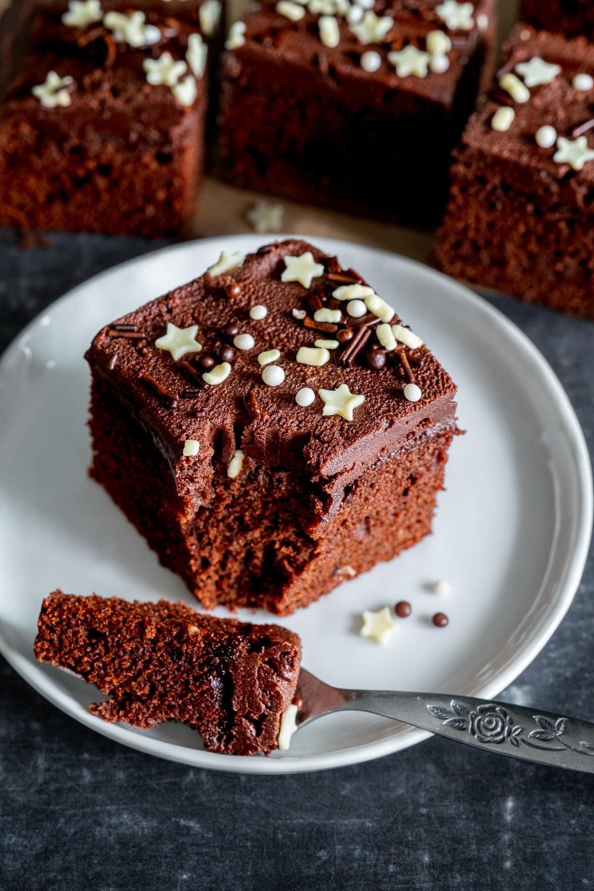 One piece of Easy Chocolate Traybake Cake on a plate.