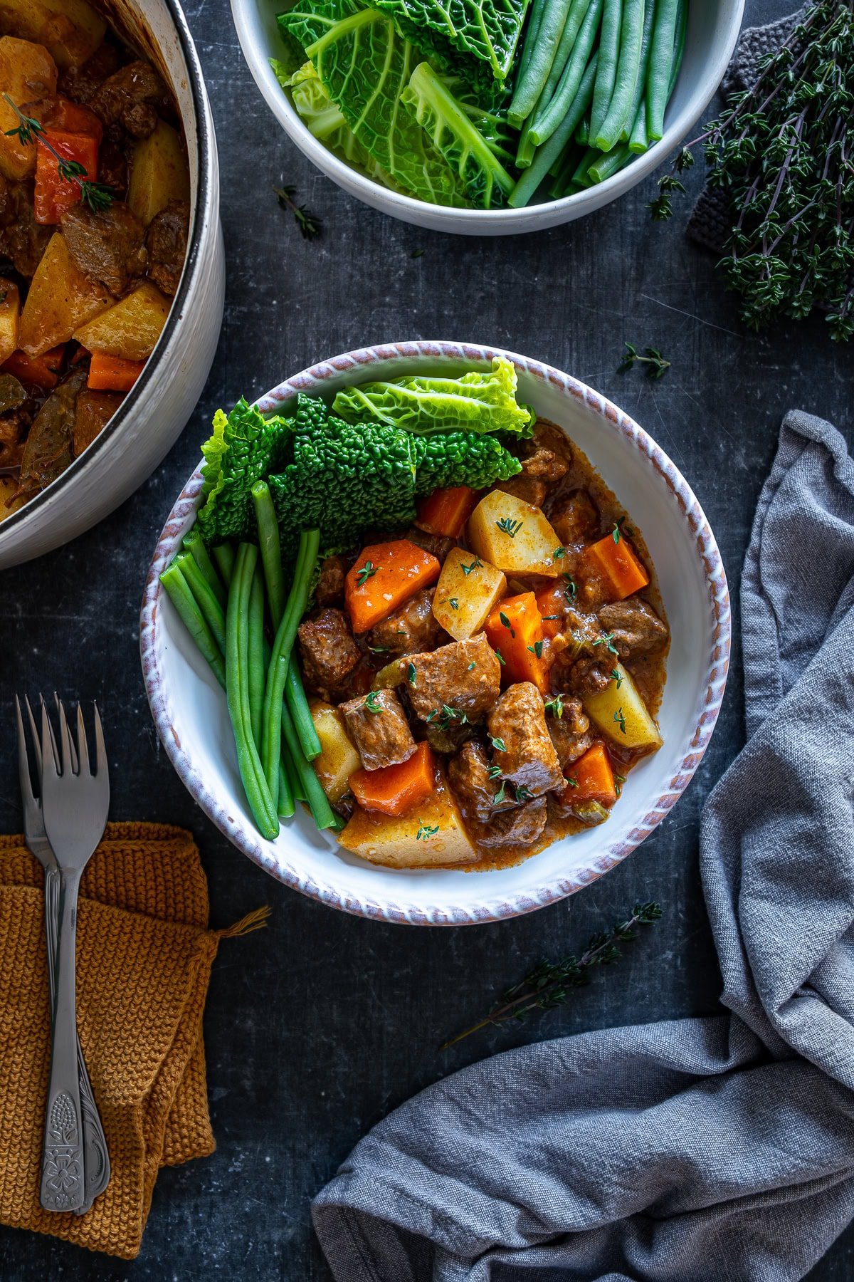 Overhead shot of Easy Beef Casserole in a bowl with cabbage and green beans.