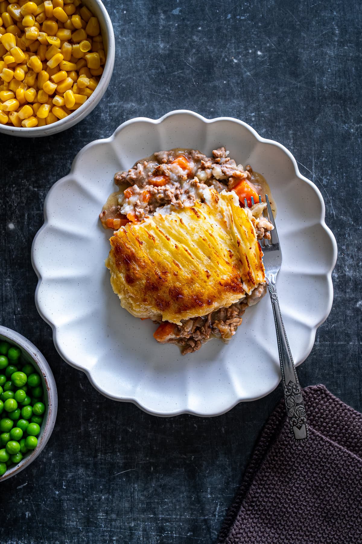 Overhead shot of one piece of Easy Peasy Shepherd’s Pie on a plate with a fork.