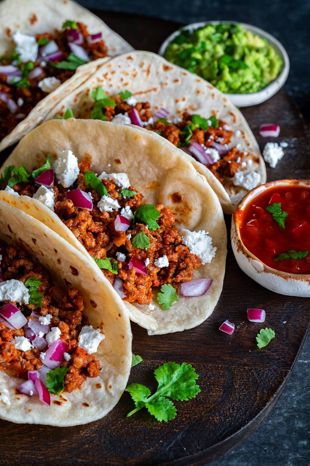 Closeup of 3 Easy Beef Mince Tacos with salsa and guacamole.