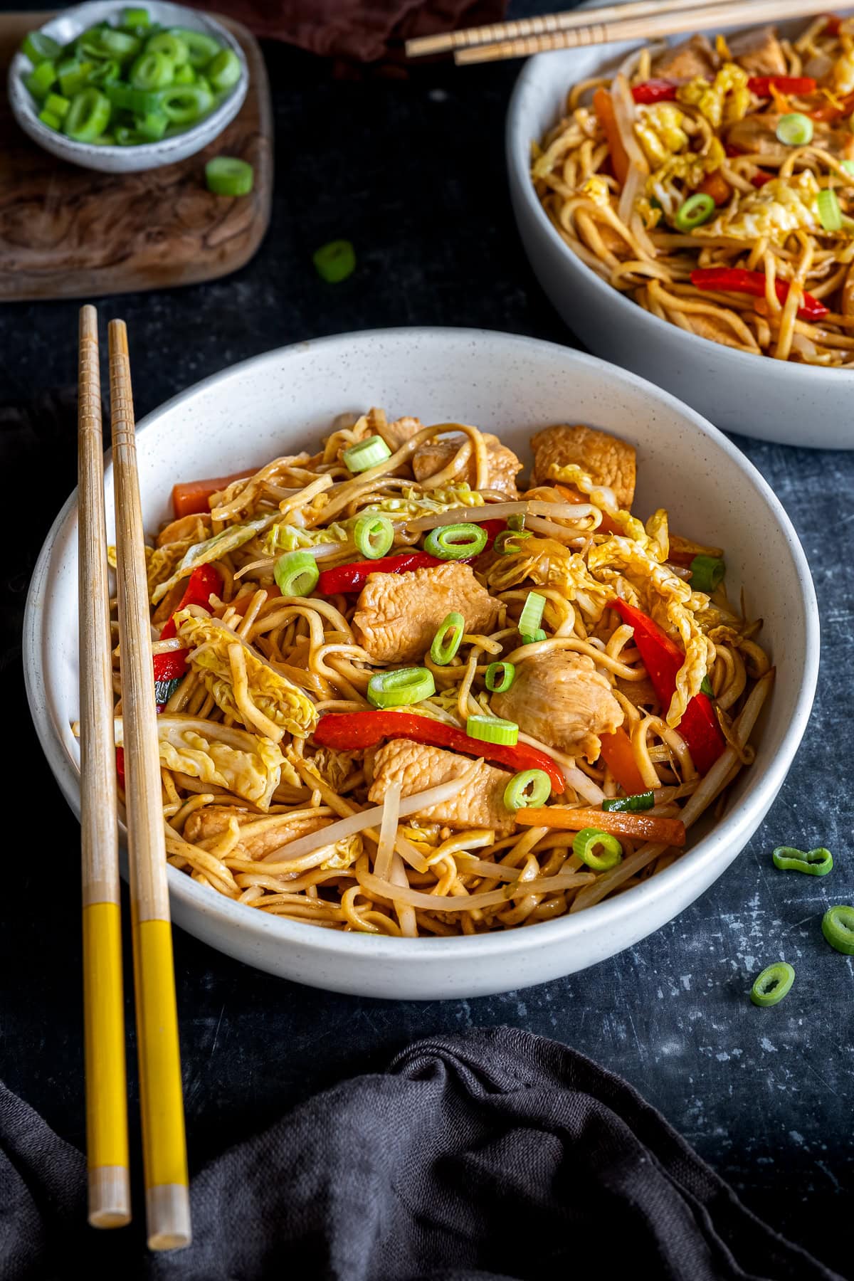 2 bowls of Chicken Chow Mein with chopsticks.