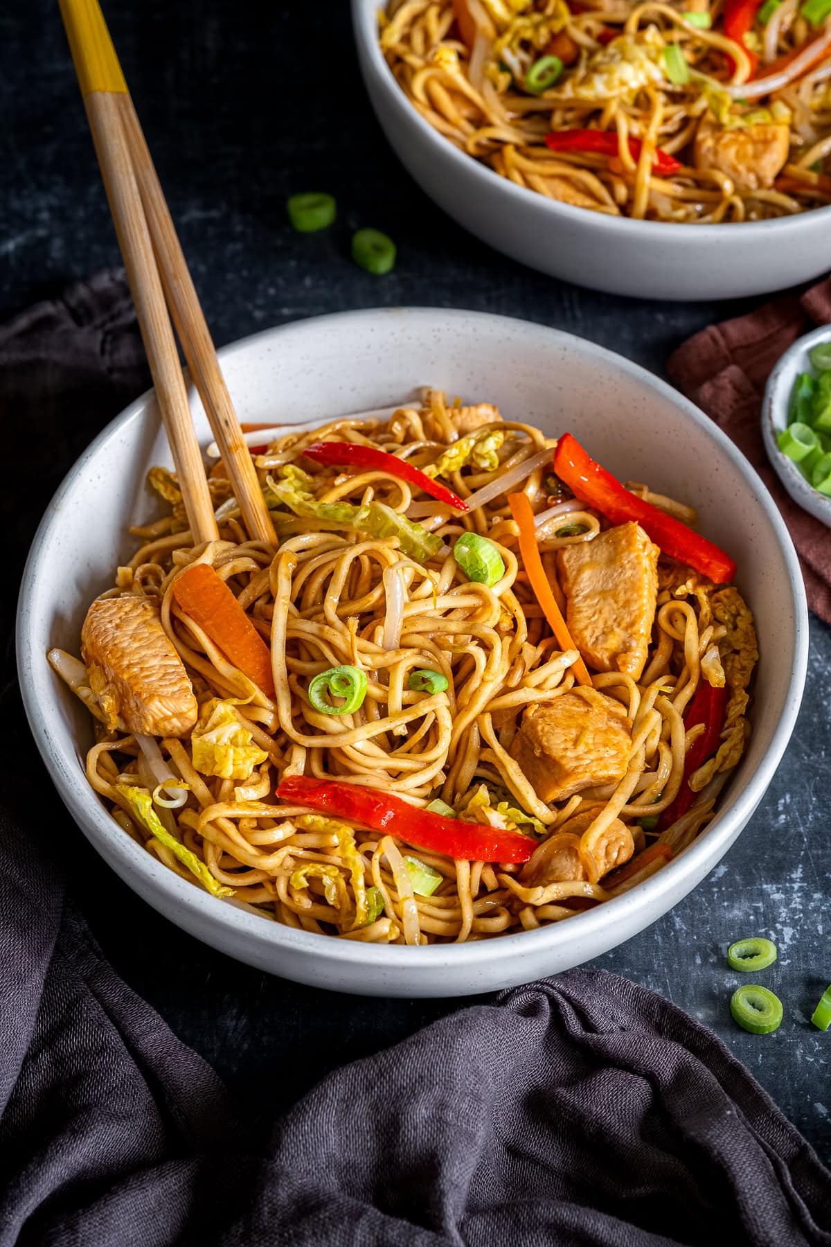 Closeup of Easy Chicken Chow Mein in a bowl with chopsticks.