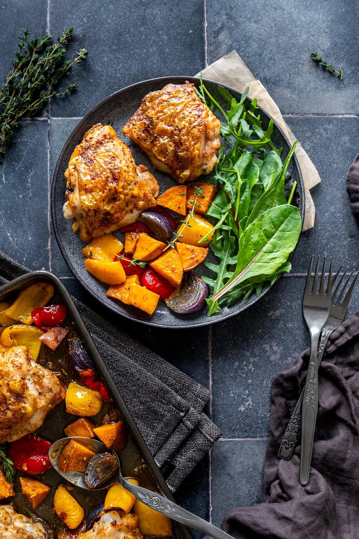Overhead shot of Easy Chicken Thigh Traybake on a plate with salad.