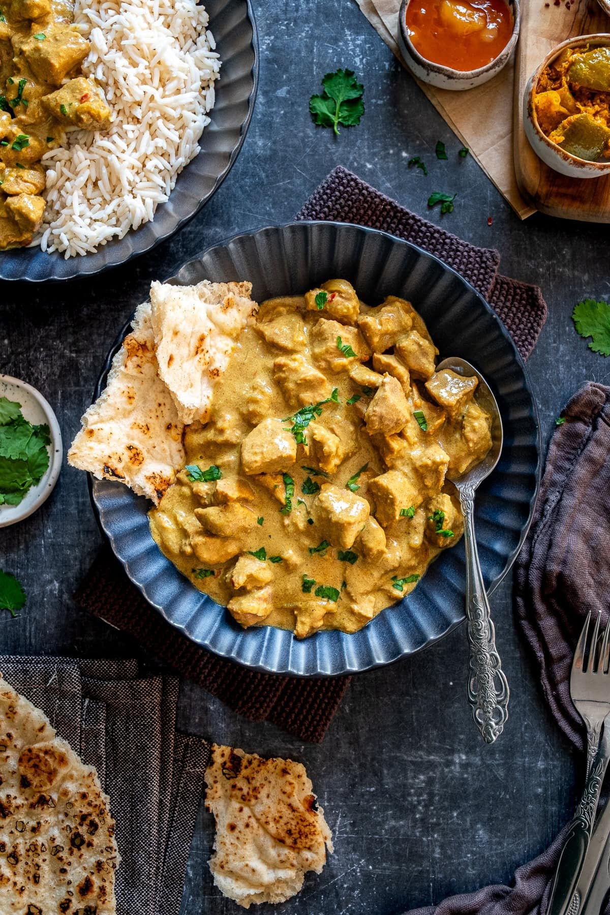 Overhead shot of Easy Lamb Korma in a bowl with naan bread.