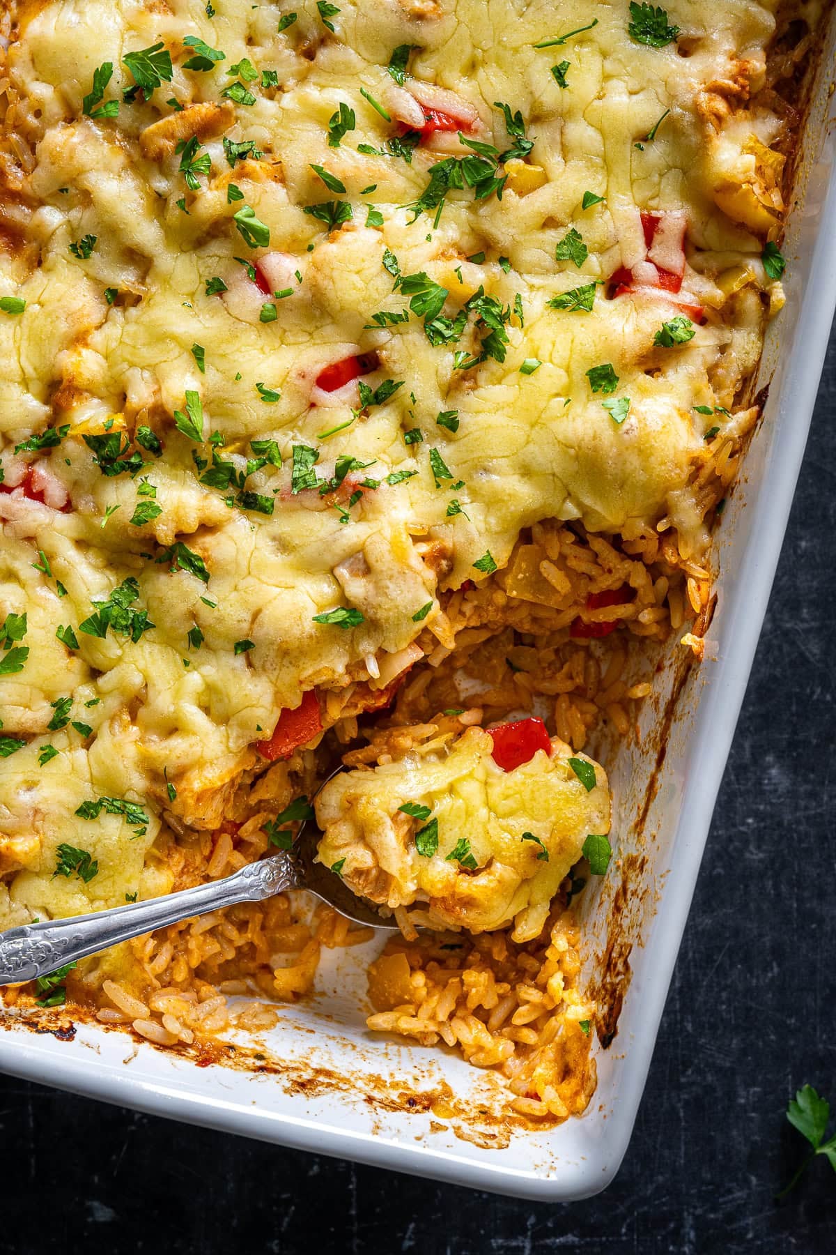 Closeup of Chicken Fajita Rice Bake with 1 scoop taken out.
