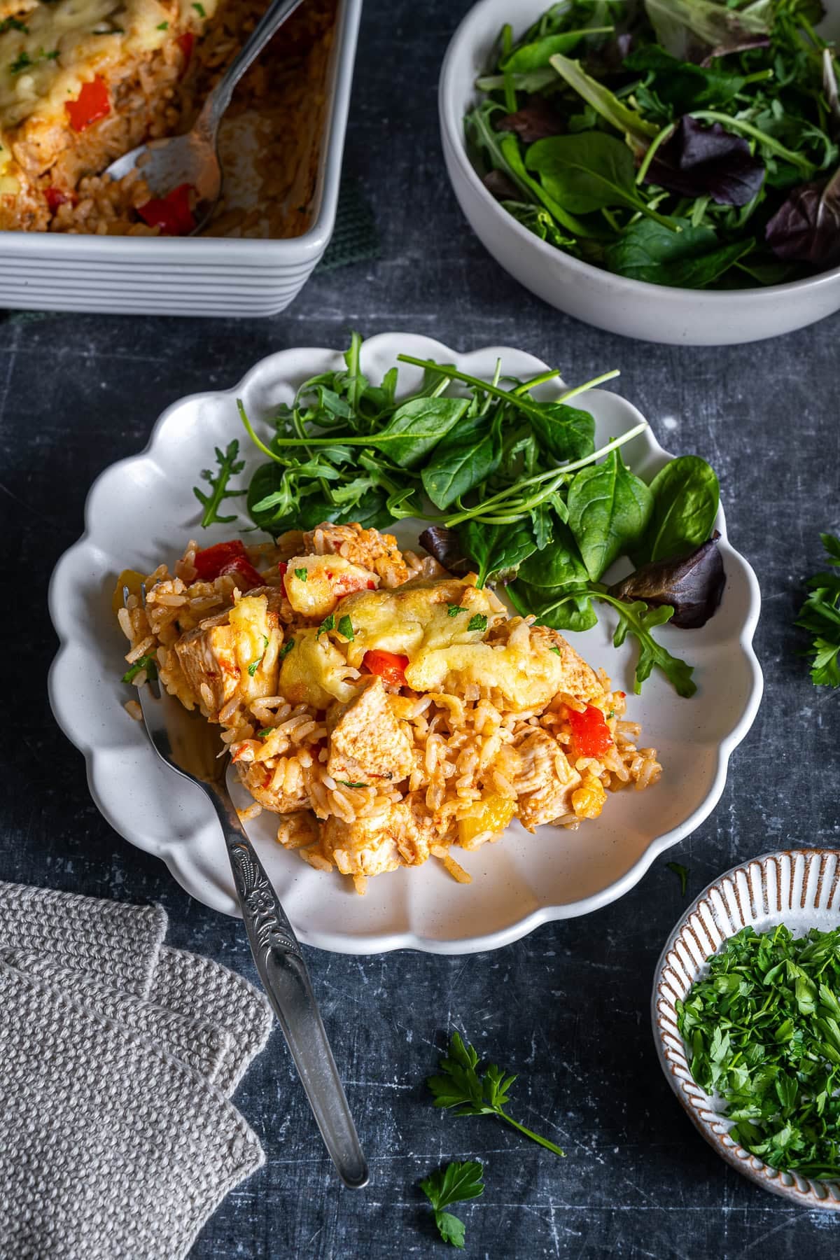Chicken Fajita Rice Bake on a plate with salad.