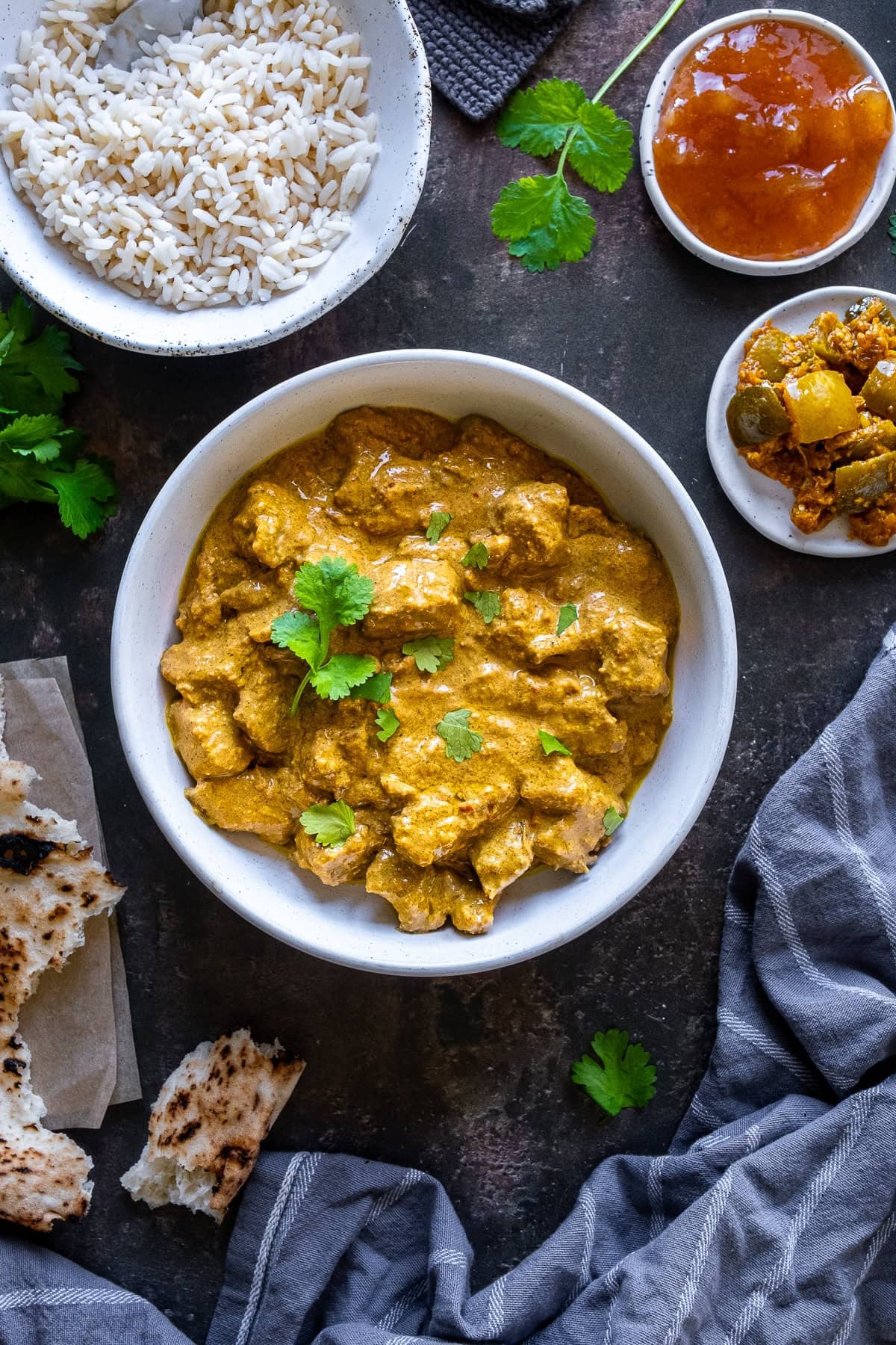 Easy Beef Korma in a bowl, surrounded by sides