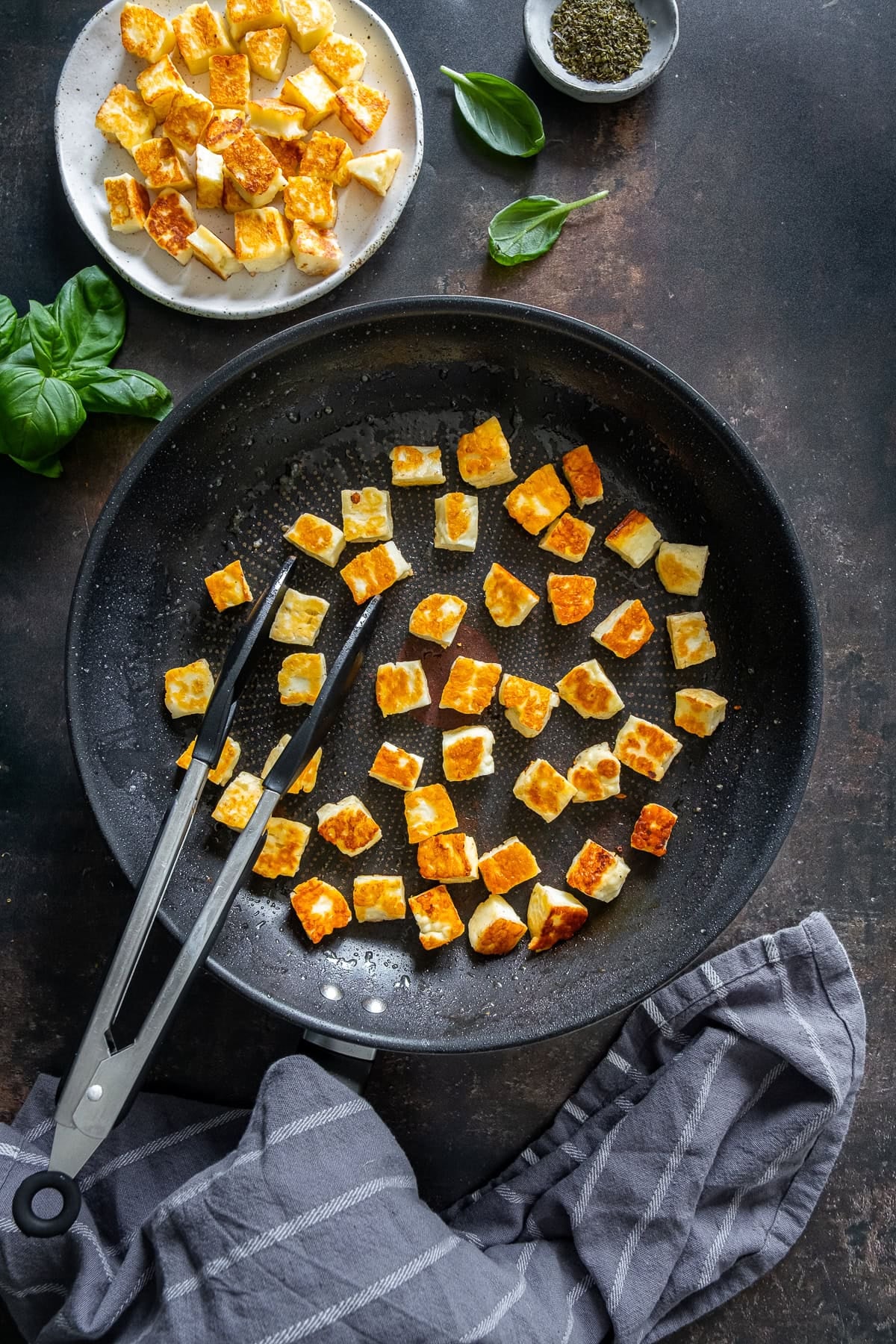 Overhead shot of perfectly fried, golden cubes of halloumi.