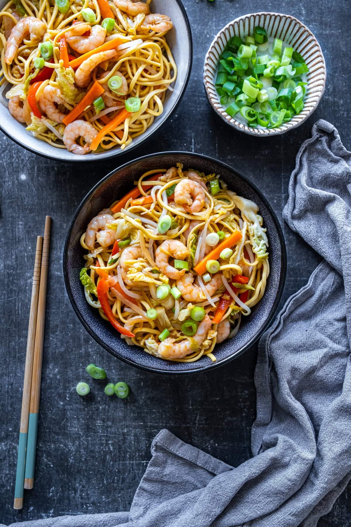 Overhead shot of 2 bowls of Prawn Chow Mein and chopsticks.