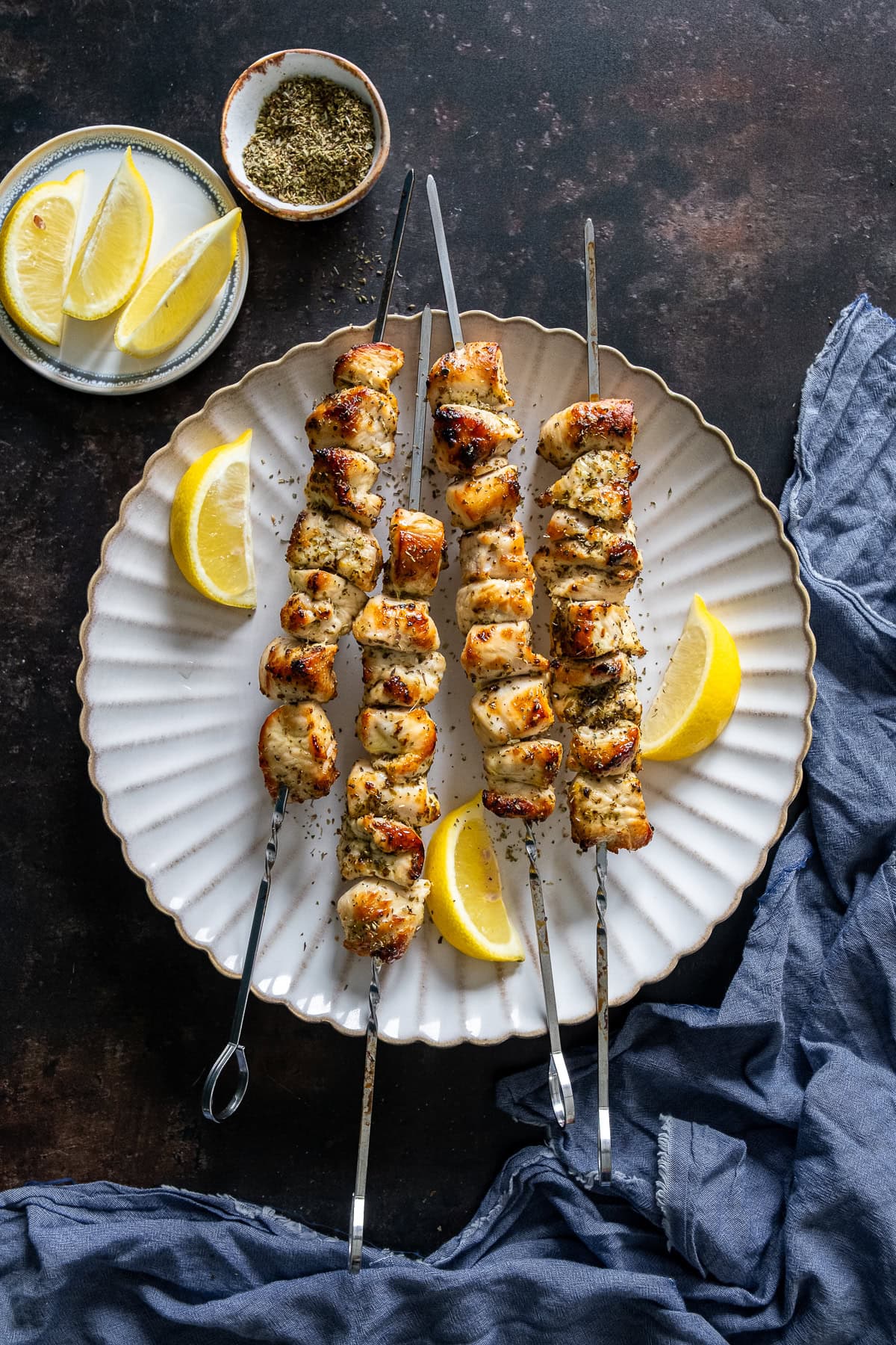Four skewers of Easy Chicken Souvlaki on a plate.