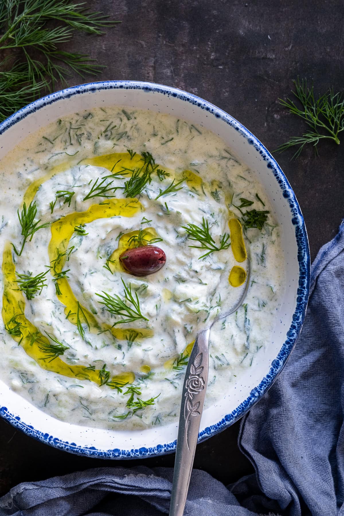 Overhead shot of Authentic Greek Tzatziki with an olive in the centre.