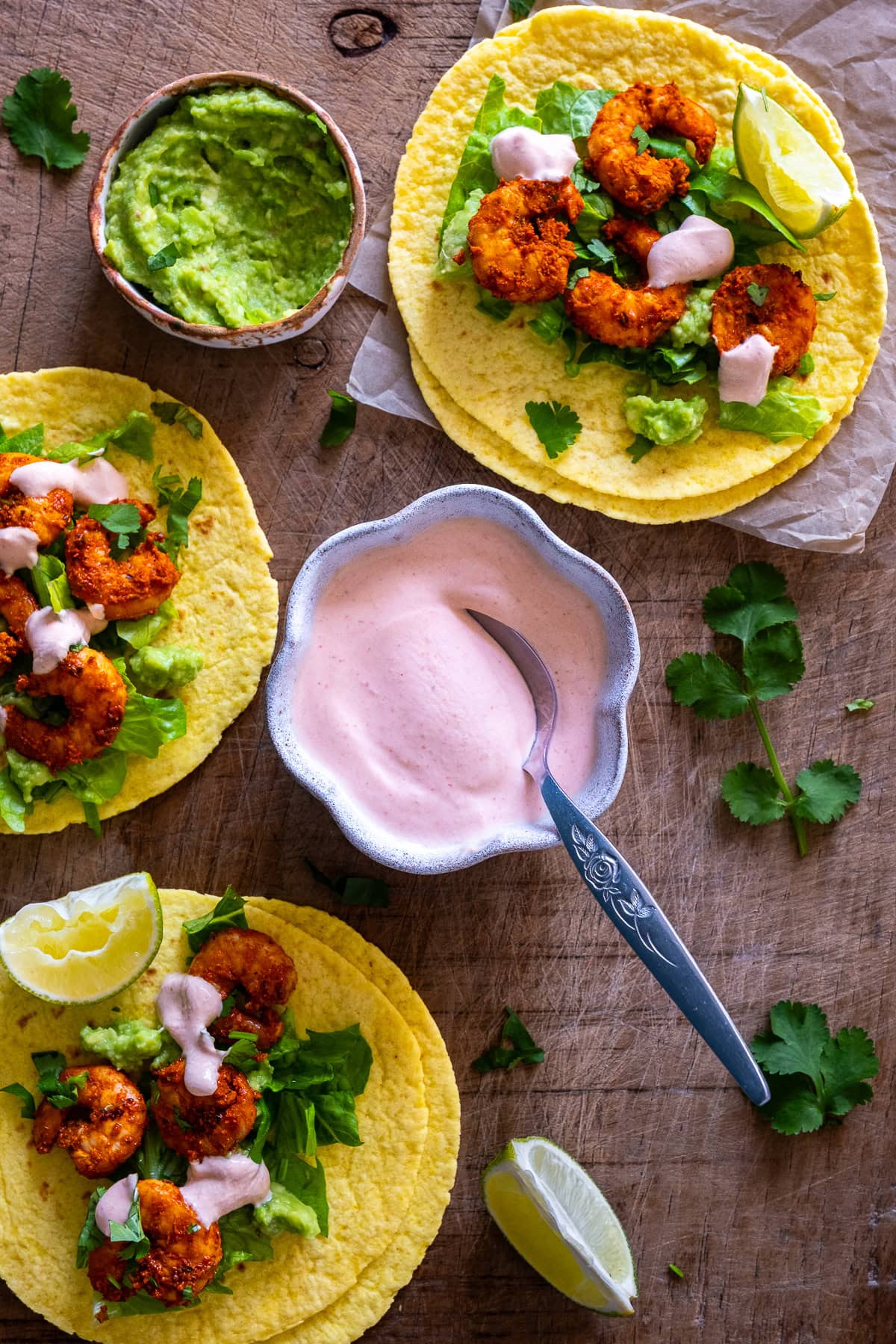 Pink Taco Sauce in a bowl, surrounded by prawn tacos.